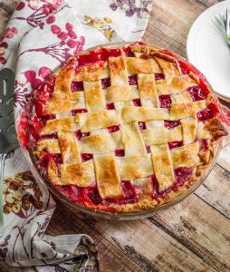 Classic Sour Cherry Pie with a Lattice Crust A sour cherry pie with a lattice crust on a table